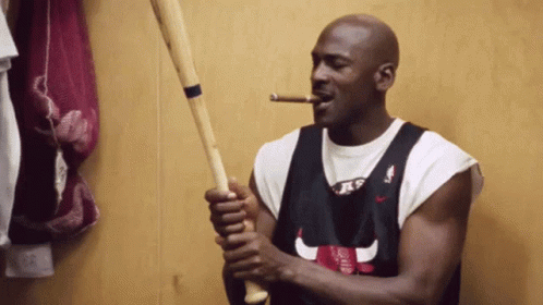 Man in Chicago Bulls Jersey Smoking Cigar Holding Baseball Bat