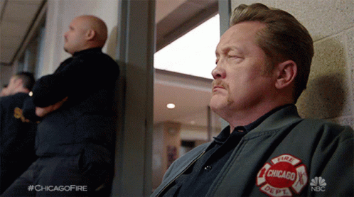 Man in Chicago Fire Department Jacket Looking Out Window