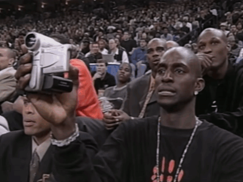 Man In Chicago Shirt Holding Video Camera GIF