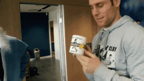 Man In Clay Shirt Holding Mug GIF