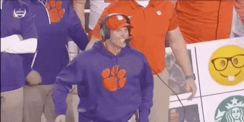 Man in Clemson Sweatshirt and Headphones in Front of Crowd