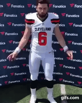 Man in Cleveland Football Uniform Standing on Field