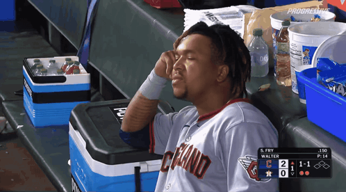 Man In Cleveland Jersey Sitting In Dugout GIF