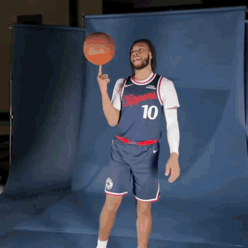 Man in Clippers Jersey Holding Basketball on Finger