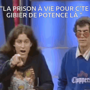 Man in Clippers Sweater Next to Pointing Woman