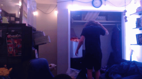 Man in Closet With Clock