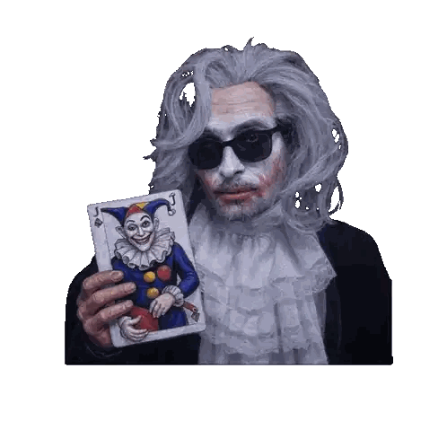 Man in Clown Costume Holding Joker Card