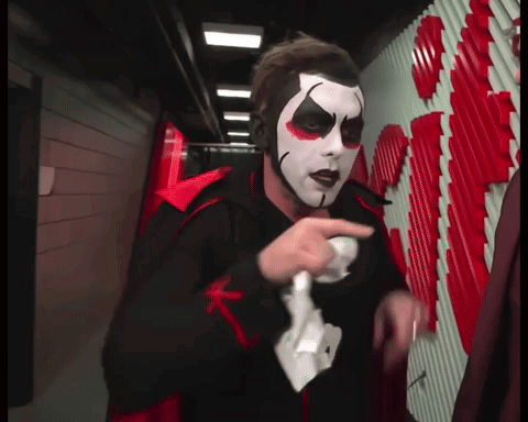Man in Clown Costume Holding Wii Remote