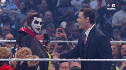 Man in Clown Mask Shaking Hands with Suit