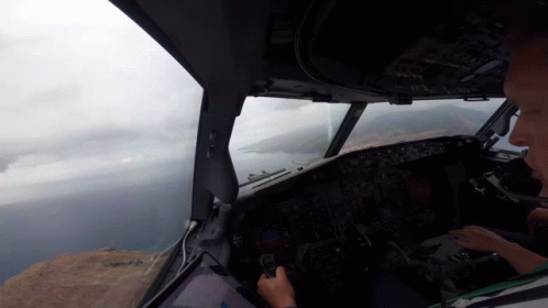 Man in Cockpit Looking Out Window