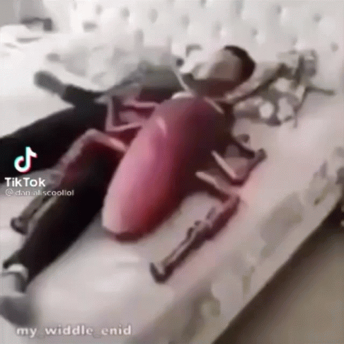 Man in Cockroach Costume Lying on Bed