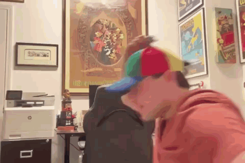 Man In Colorful Hat At Desk With HP Printer GIF