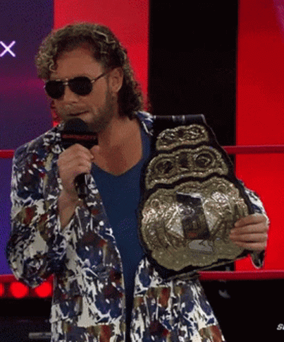 Man in Colorful Jacket Holding Wrestling Championship Belt