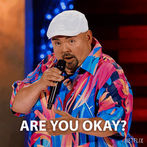 Man in Colorful Shirt Holding Microphone Says Are You Okay