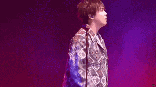 Man in Colorful Shirt on Stage