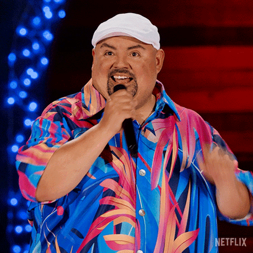 Man in Colorful Shirt Singing Into Microphone With Netflix Logo