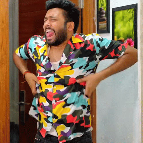 Man In Colorful Shirt Standing Hands On Hips GIF
