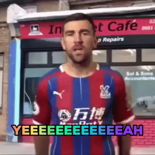 Man in Colorful Shirt Standing in Front of Store