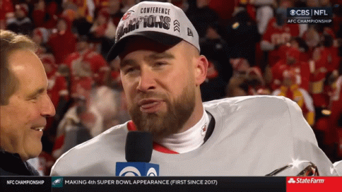 Man in Conference Champions Hat Interviewed by Reporter