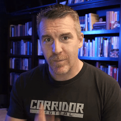 Man in Corridor Digital T-Shirt in Front of Bookshelf
