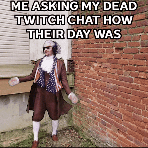 Man in Costume in Front of Brick Wall