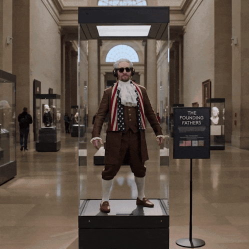 Man In Costume In Glass Case Saying The Founding Fathers GIF