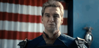 Man In Costume Standing Before American Flag GIF
