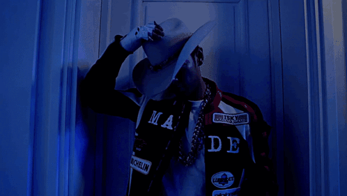 Man In Cowboy Hat And Bandana GIF