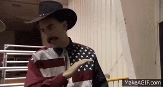 Man In Cowboy Hat And Flag Shirt Pointing GIF