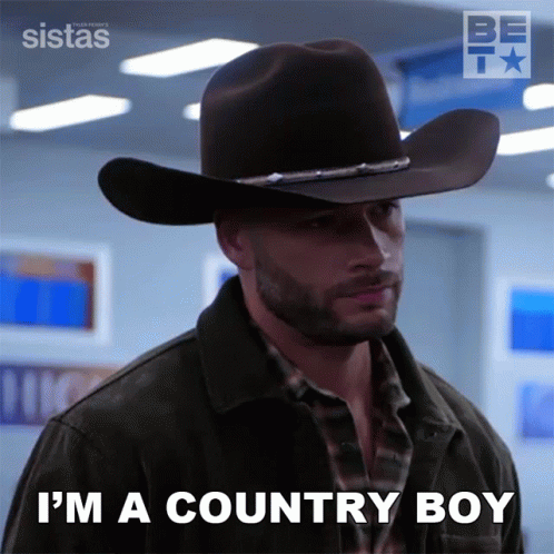 Man in Cowboy Hat and Jacket Says I'm a Country Boy