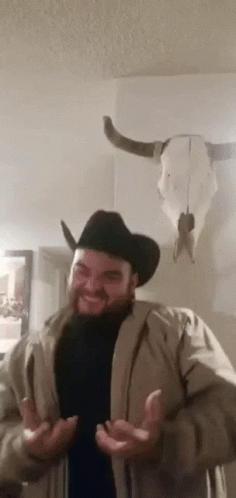 Man in Cowboy Hat and Jacket With Cow Skull