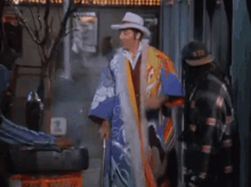 Man In Cowboy Hat And Kimono Next To Man In Leather Jacket GIF