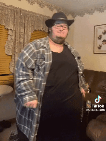 Man in Cowboy Hat and Plaid Shirt Dancing