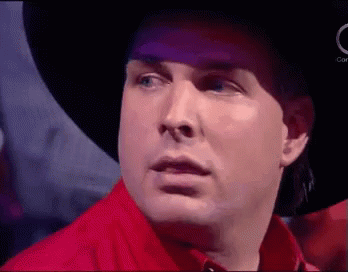 Man In Cowboy Hat And Red Shirt Making Funny Face GIF