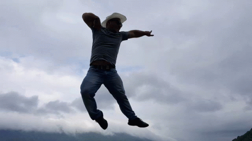 Man In Cowboy Hat And Sunglasses Jumping GIF
