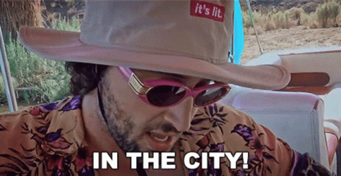 Man in Cowboy Hat and Sunglasses Says in the City
