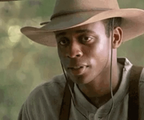 Man in Cowboy Hat and Suspenders