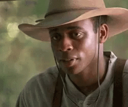 Man in Cowboy Hat and Suspenders Looking Sideways