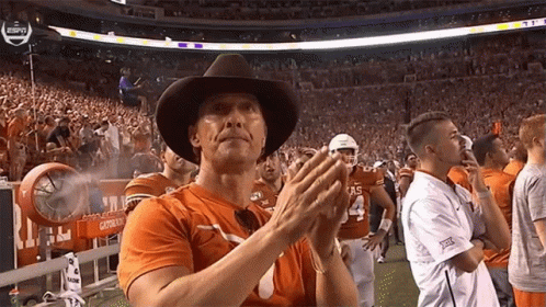 Man in Cowboy Hat and Texas Shirt Clapping