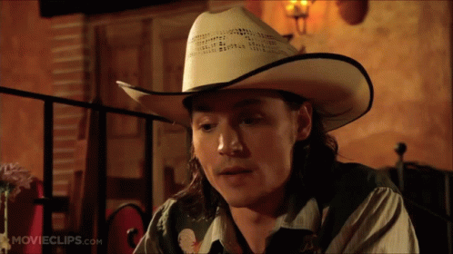 Man in Cowboy Hat at Table
