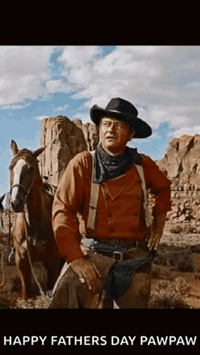 Man in Cowboy Hat Beside Horse in Desert