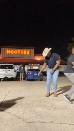 Man in Cowboy Hat Dancing at Hooters