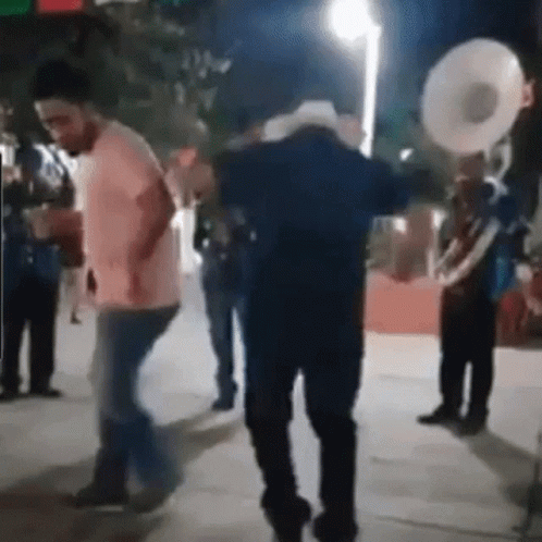 Man in Cowboy Hat Dancing With Band