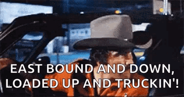 Man in Cowboy Hat Driving Car East Bound and Down Loaded Up and Truckin