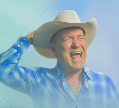 Man in Cowboy Hat Giving Thumbs Up