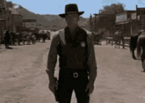 Man in Cowboy Hat Holding Gun