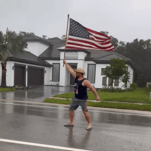 Man In Cowboy Hat Holding Large American Flag GIF