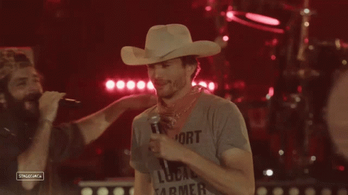 Man in Cowboy Hat Holding Microphone
