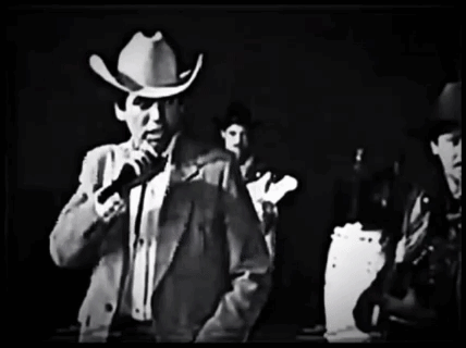 Man In Cowboy Hat Holding Microphone GIF