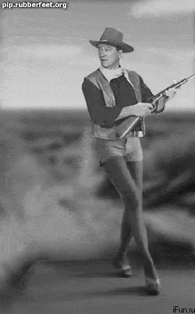 Man in Cowboy Hat Holding Rifle